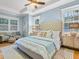 Serene main bedroom with plush bedding and seating area, lots of natural light at 1810 Lincoln Dr, Sarasota, FL 34236