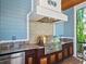 Stainless steel grill, granite counters, and custom cabinetry in this outdoor kitchen at 1810 Lincoln Dr, Sarasota, FL 34236
