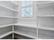 Bright and spacious pantry with white shelves and window at 1810 Lincoln Dr, Sarasota, FL 34236