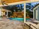 Inviting pool area with waterfall feature and covered patio at 1810 Lincoln Dr, Sarasota, FL 34236