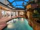 Enjoy this luxurious pool and patio area at night at 1810 Lincoln Dr, Sarasota, FL 34236