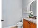 Small powder room with granite vanity and decorative accents at 1810 Lincoln Dr, Sarasota, FL 34236