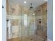 Large walk-in shower with beige stone tile and glass enclosure at 1810 Lincoln Dr, Sarasota, FL 34236