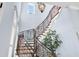 Elegant curved staircase with ornate metal railing at 1810 Lincoln Dr, Sarasota, FL 34236
