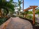 Brick walkway with pergola and lush landscaping at 1810 Lincoln Dr, Sarasota, FL 34236