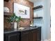 Custom wet bar with brick wall and shelving for storage at 1810 Lincoln Dr, Sarasota, FL 34236