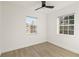 Bright bedroom featuring wood-look floors and two windows for ample natural light at 21907 Cellini Ave, Port Charlotte, FL 33952