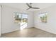 Bright bedroom with two windows, ceiling fan, and light flooring at 21907 Cellini Ave, Port Charlotte, FL 33952