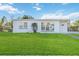 Newly renovated home with a modern facade and lush lawn at 21907 Cellini Ave, Port Charlotte, FL 33952