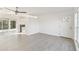 Cozy living room featuring a view to the kitchen and sliding door access at 21907 Cellini Ave, Port Charlotte, FL 33952