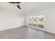 Bright living room features large windows, ceiling fan, and neutral paint palette at 21907 Cellini Ave, Port Charlotte, FL 33952