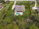 Aerial view of house, pool, and surrounding landscape at 22343 Panther Loop, Bradenton, FL 34202