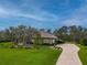 House with stone facade and landscaping, paved driveway, and walkway at 22343 Panther Loop, Bradenton, FL 34202