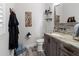 Rustic-style bathroom with granite countertop, wooden cabinets, and decorative wall art at 22343 Panther Loop, Bradenton, FL 34202