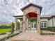 Elegant entrance with stone pillars and double doors at 22343 Panther Loop, Bradenton, FL 34202