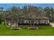 House exterior with stone and stucco, landscaping, and a walkway at 22343 Panther Loop, Bradenton, FL 34202