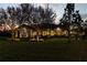 House exterior at dusk with landscape lighting at 22343 Panther Loop, Bradenton, FL 34202