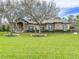 One-story home with stone accents and manicured lawn at 22343 Panther Loop, Bradenton, FL 34202