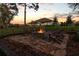Stone fire pit surrounded by comfortable seating in the backyard at 22343 Panther Loop, Bradenton, FL 34202