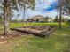 Landscaped firepit area with wooden chairs and stone pathway at 22343 Panther Loop, Bradenton, FL 34202