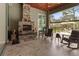 Stone fireplace on the patio with seating for relaxation at 22343 Panther Loop, Bradenton, FL 34202