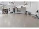 Spacious garage with overhead storage, epoxy flooring, and ample space for vehicles at 22343 Panther Loop, Bradenton, FL 34202