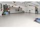 Large garage, featuring overhead storage and epoxy flooring at 22343 Panther Loop, Bradenton, FL 34202