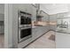 Modern kitchen featuring stainless steel appliances and gray cabinets at 22343 Panther Loop, Bradenton, FL 34202