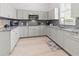 L-shaped kitchen with granite countertops and stainless steel appliances at 22343 Panther Loop, Bradenton, FL 34202