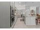 Gourmet kitchen with granite countertops, stainless steel appliances, and gray cabinetry at 22343 Panther Loop, Bradenton, FL 34202