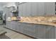 Gray kitchen cabinets and granite countertops with tile backsplash at 22343 Panther Loop, Bradenton, FL 34202