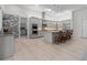 Open kitchen with island, granite counters, and stainless steel appliances at 22343 Panther Loop, Bradenton, FL 34202
