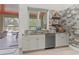 Kitchenette with granite counters, stainless steel dishwasher, and view of pool at 22343 Panther Loop, Bradenton, FL 34202