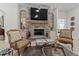 Elegant living room featuring a stone fireplace and comfortable seating at 22343 Panther Loop, Bradenton, FL 34202