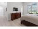 Main bedroom with a large TV and built-in dresser at 22343 Panther Loop, Bradenton, FL 34202