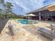 Inviting pool area with lounge chairs and umbrellas at 22343 Panther Loop, Bradenton, FL 34202