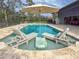 Relax by the pool under the shade of an umbrella on comfortable lounge chairs at 22343 Panther Loop, Bradenton, FL 34202