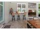 Outdoor patio with bar seating, wooden table, and access to the main house at 22343 Panther Loop, Bradenton, FL 34202
