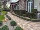 Brick walkway lined with bushes leading to entrance at 22343 Panther Loop, Bradenton, FL 34202