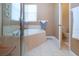 Bathroom with soaking tub, shower, and neutral tile floors at 236 Golden Harbour Trl, Bradenton, FL 34212