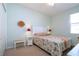 Charming bedroom with a queen bed, updated decor, and a ceiling fan at 236 Golden Harbour Trl, Bradenton, FL 34212
