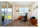 Bright home office with a desk, chair, and view of the lake at 236 Golden Harbour Trl, Bradenton, FL 34212