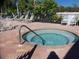 Community hot tub with surrounding lounge chairs at 236 Golden Harbour Trl, Bradenton, FL 34212