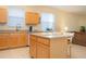 Kitchen features island, light wood cabinets, and stainless steel appliances at 236 Golden Harbour Trl, Bradenton, FL 34212
