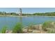 Lakefront view with lighthouse and lush vegetation at 236 Golden Harbour Trl, Bradenton, FL 34212