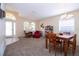 Open living and dining area with rocking chair and table at 236 Golden Harbour Trl, Bradenton, FL 34212