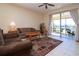 Living room with sliding doors to screened patio overlooking lake at 236 Golden Harbour Trl, Bradenton, FL 34212