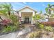 Home's entrance with lush tropical landscaping at 2426 Icecapade Dr, Sarasota, FL 34240