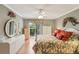 Bright bedroom features floral bedding, ceiling fan, and plenty of closet space at 3001 Seawind Cir # 10C, Venice, FL 34293