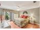 Spacious bedroom with floral bedding, ceiling fan, and private access to patio at 3001 Seawind Cir # 10C, Venice, FL 34293